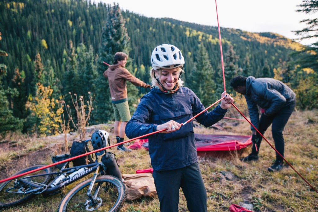 Bikepacker setting up tent, Picture